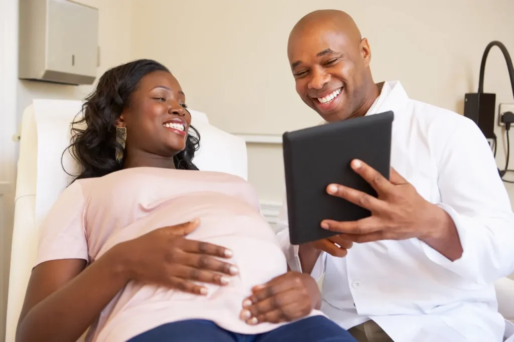 A man and woman looking at an ipad.