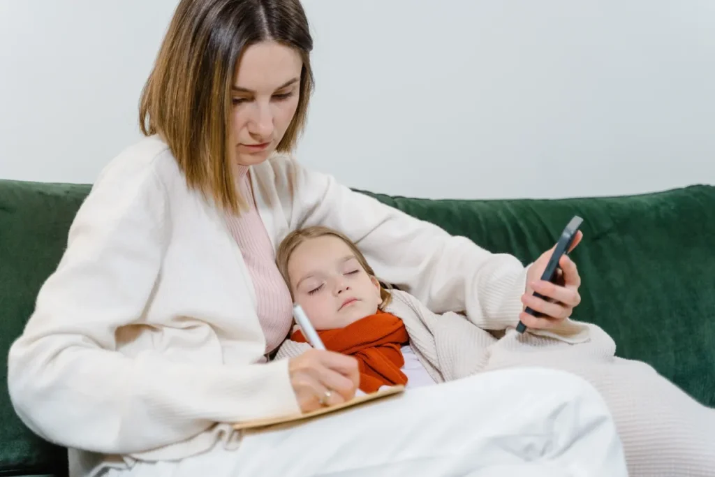 A woman and child are sitting on the bed