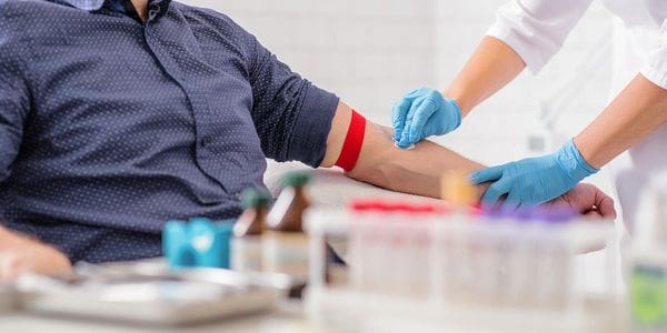 A person is getting their arm examined by an employee.