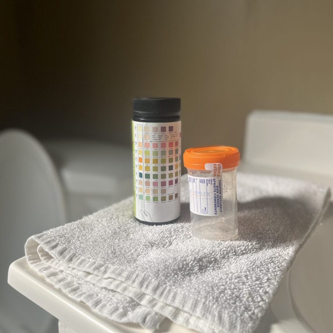 A table with two pill bottles and a towel.