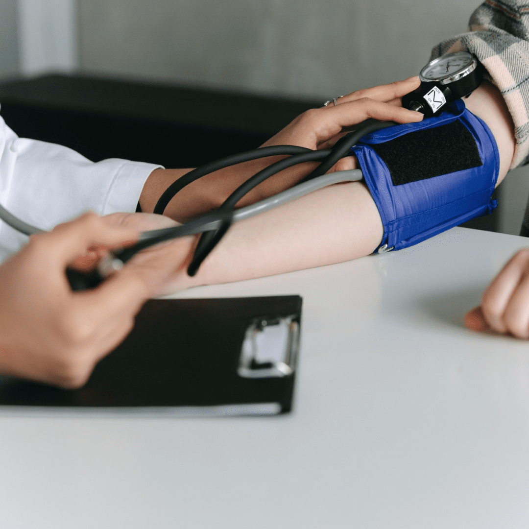 A person is taking blood pressure with a stethoscope.