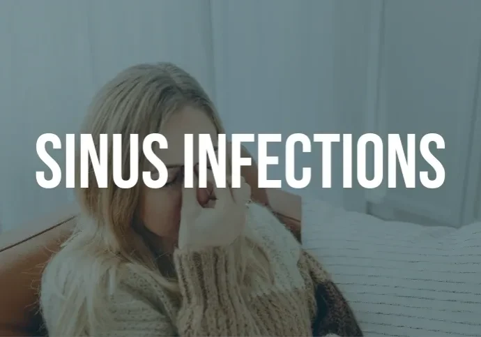 A woman with her hand over her face and the words sinus infection written in white.