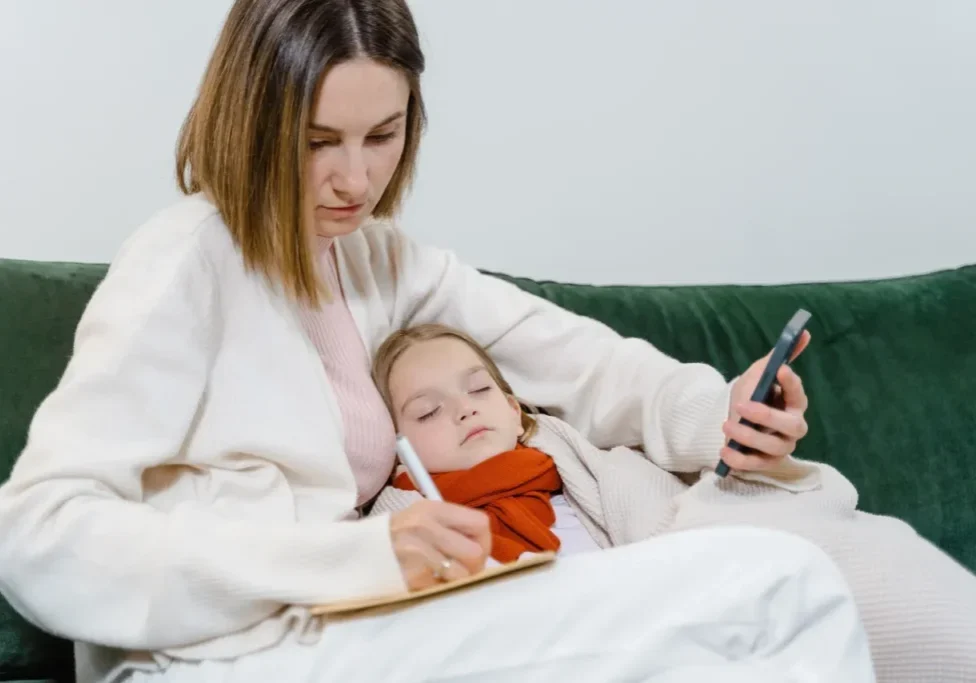 A woman and child are sitting on the bed